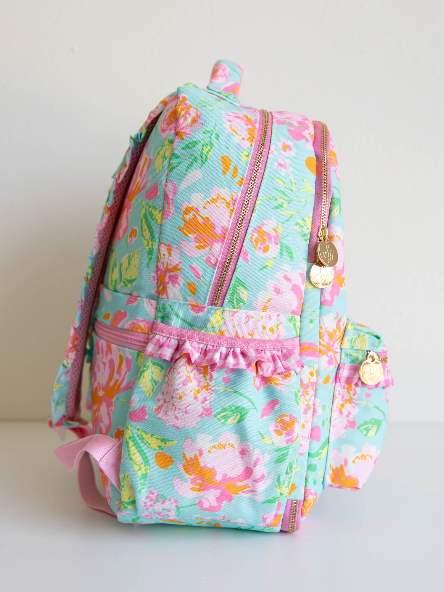 colorful and floral backpack with zippers, ruffles and front pocket