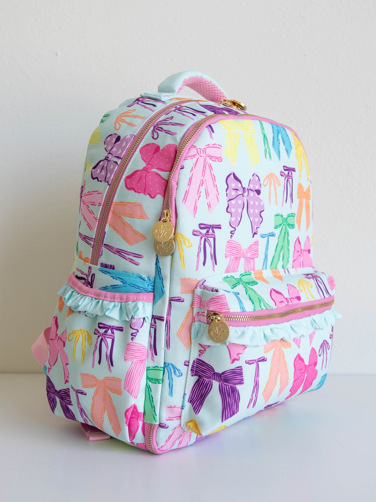 Vibrant bows colored backpack with gold zippers and zipper pulls