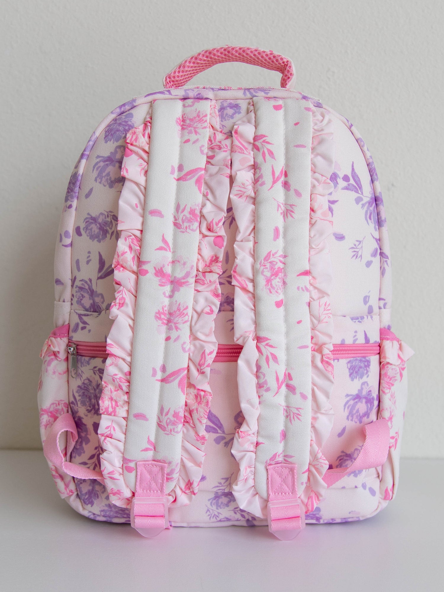 Floral backpack with ruffed back straps