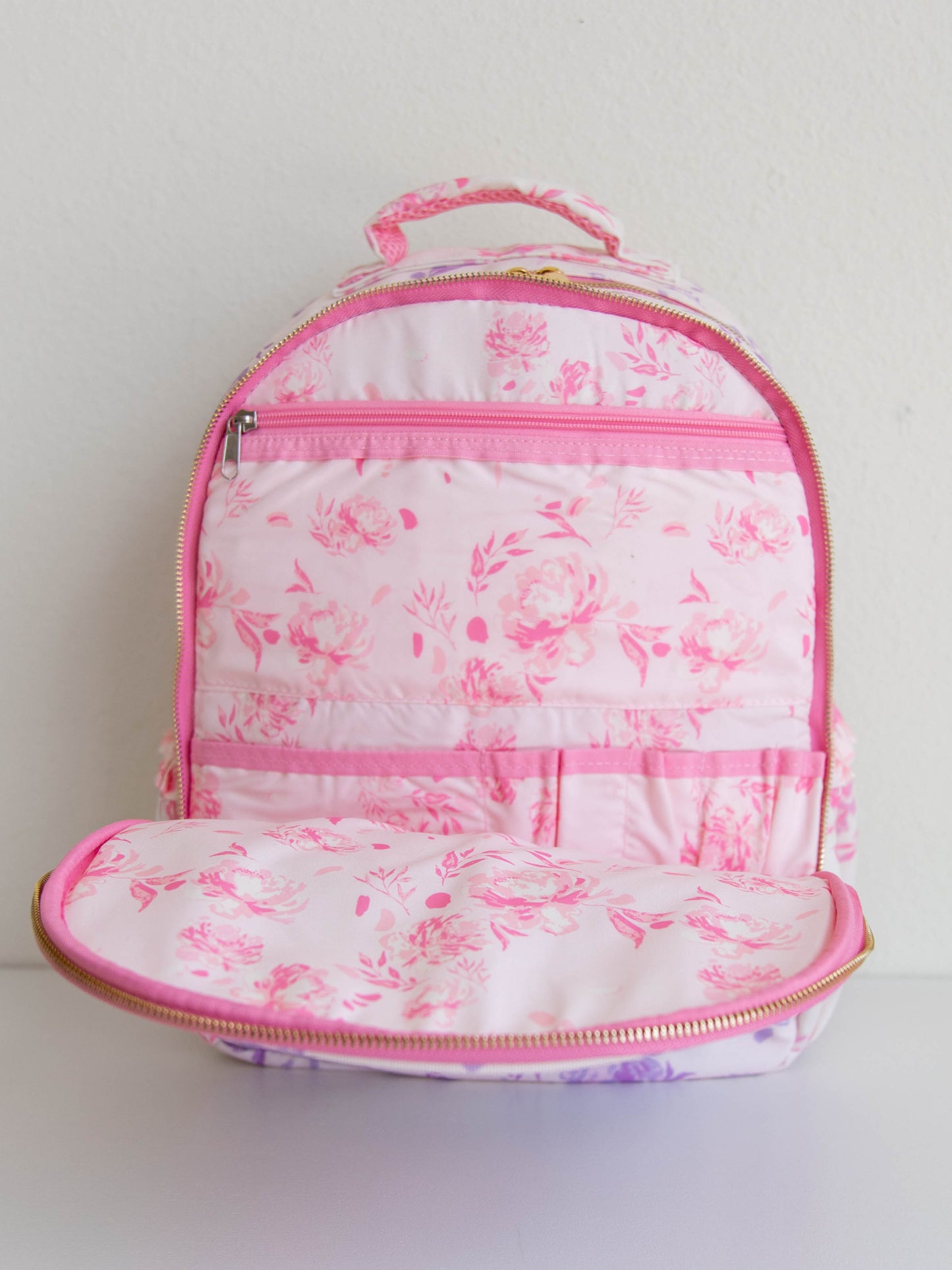 Inside of floral backpack that shows different compartments 