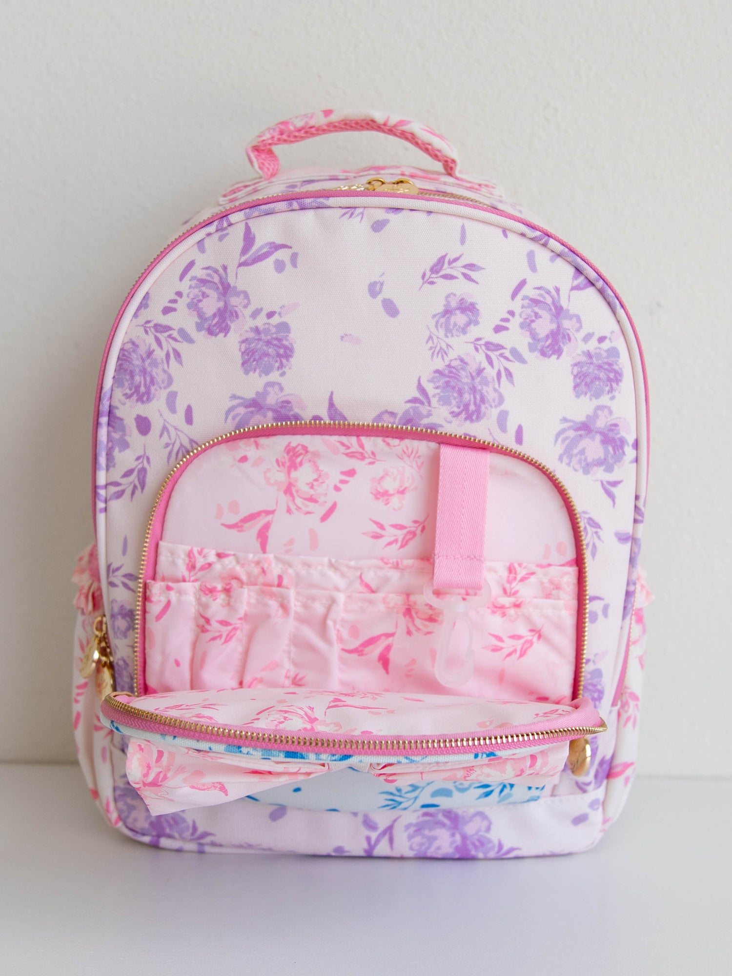 Inside front zipper of floral backpack. Pic shows different compartments. 