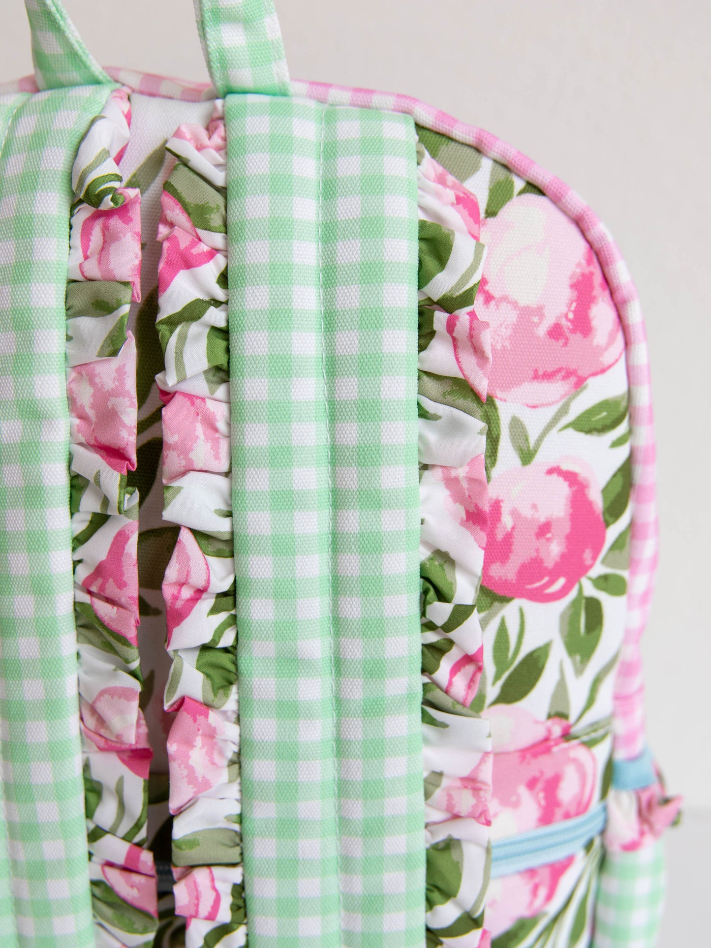 Mint green backpack straps on a floral backpack