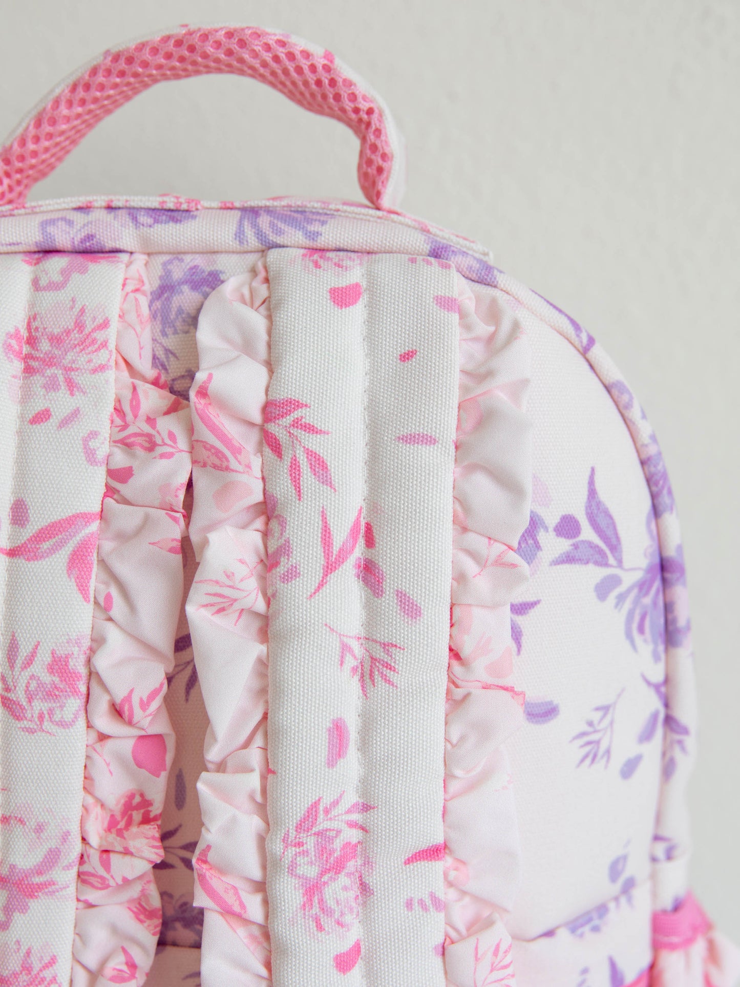 Zoomed in picture of the back of the backpack showing ruffled straps