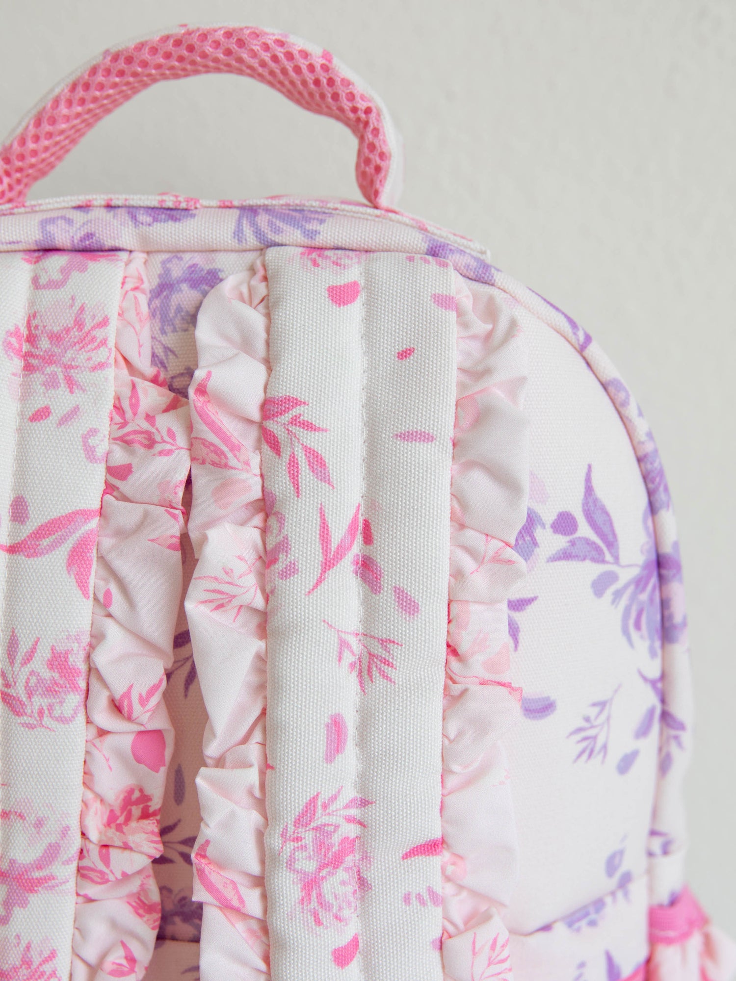 Zoomed in picture of the back of the backpack showing ruffled straps
