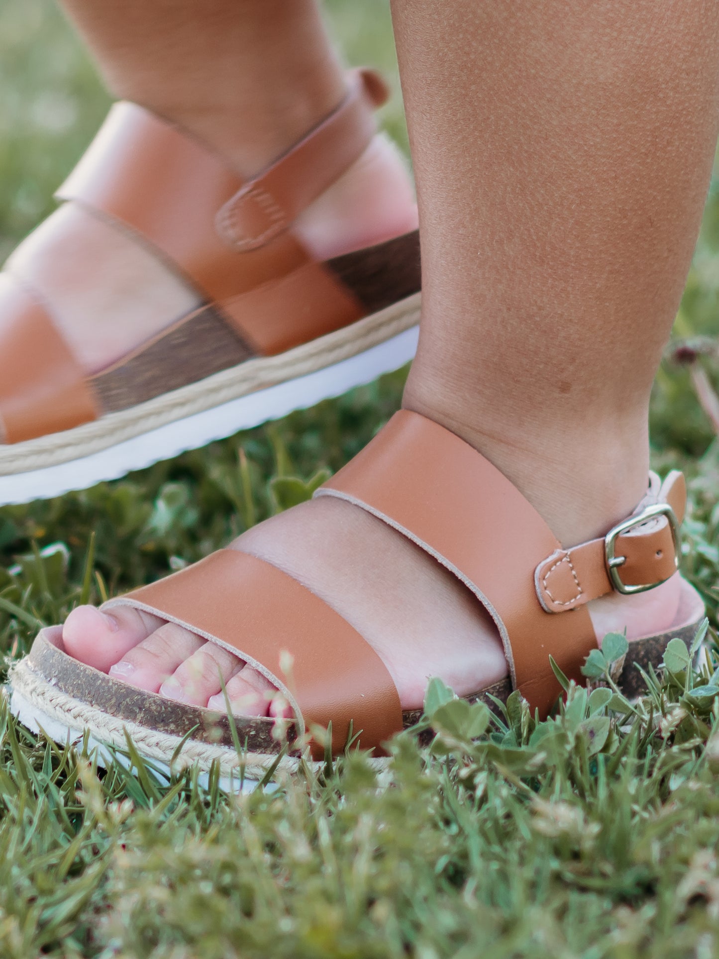 These Strappy Cork Sandals are made of wide strips of Brown manmade leather, cork sole, and have a metal adjustable buckle.