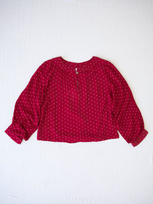 Women's Long Sleeve Blouse - Christmas Dotty. This long-sleeved blouse comes in a pattern of white polka dots on a red background. 