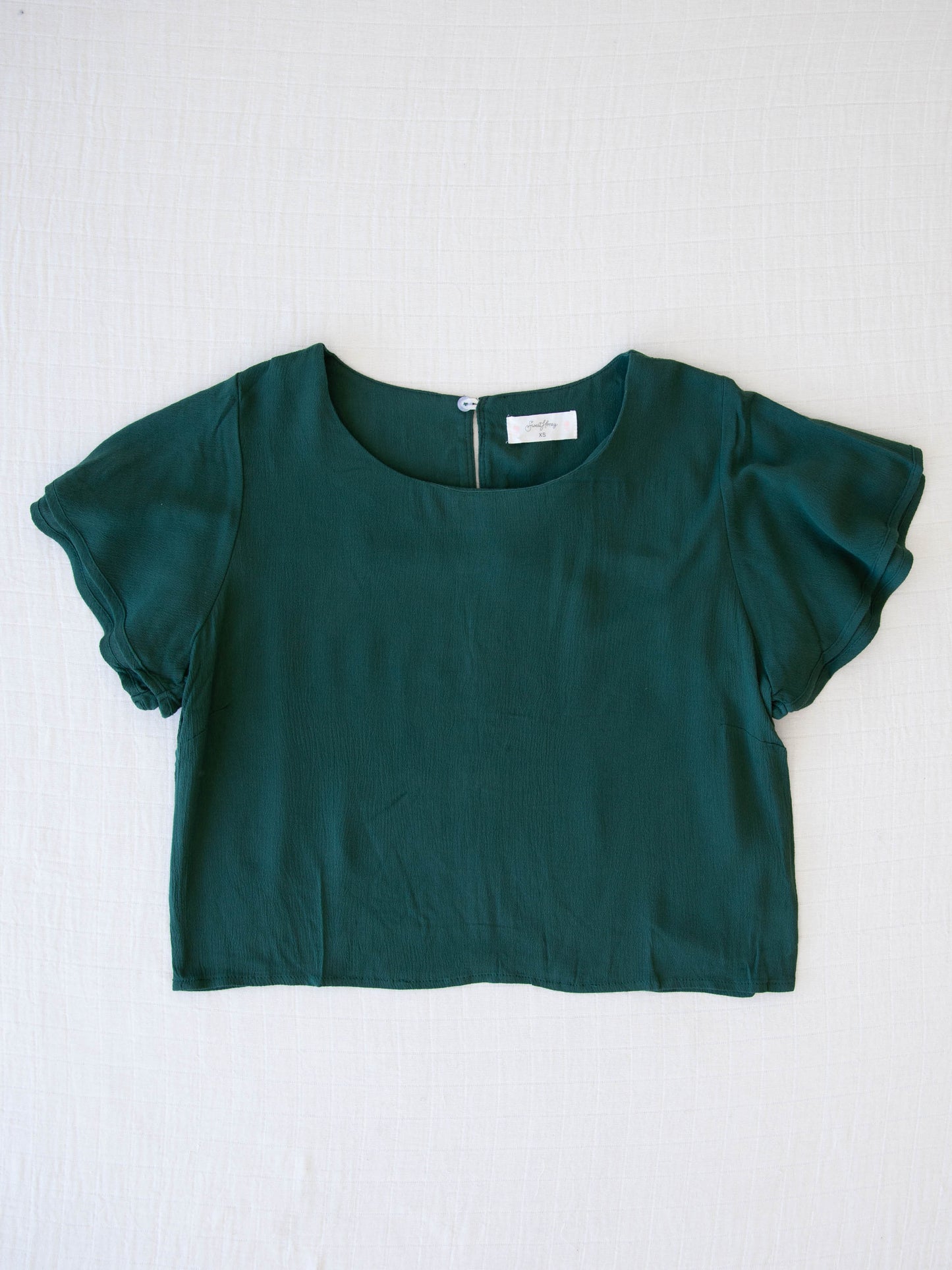 Women's Flutter Top - Green. This top has double ruffled fluttery short sleeves and comes in a dark green color. 