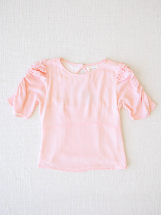 Classic Smocked Cutout Top – Soft Pink. This short sleeve top has a smocked and keyhole back, and synched sleeves. 