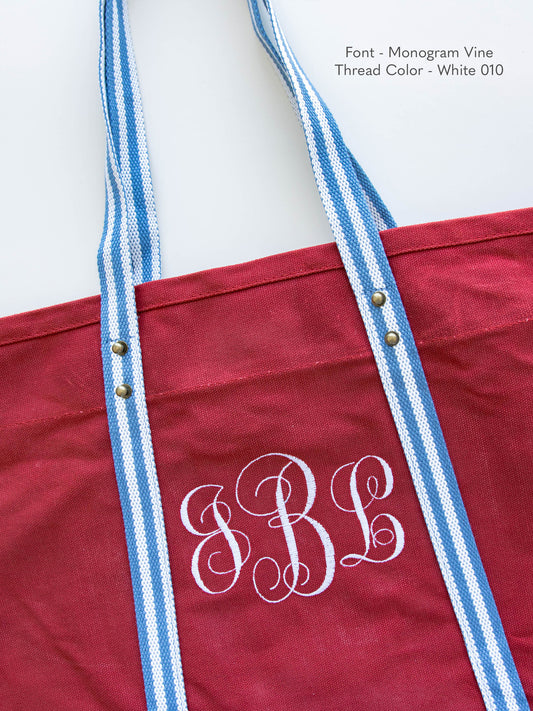 Closeup of one of the embroidery options available on our Canvas Totes. This one uses the font Monogram Vine and White thread.