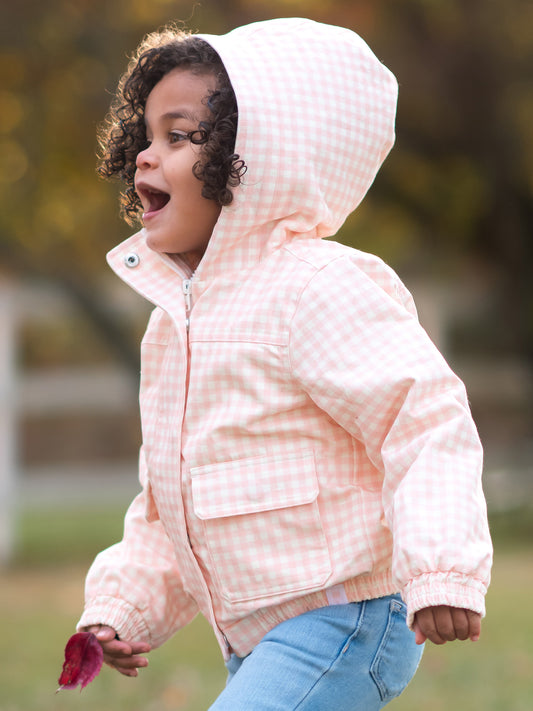 This image of a girl features the product Sherpa Lined Hooded Jacket - Pink Check. It comes in a pattern of pale pink check.