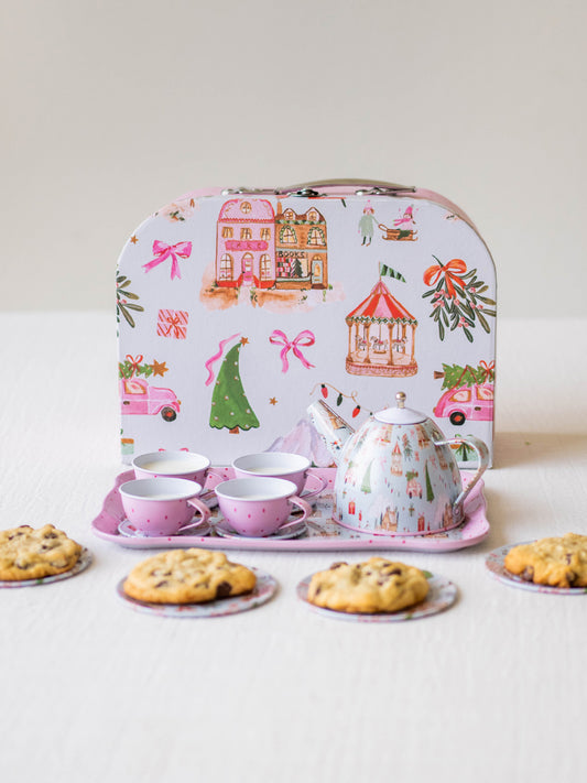 The serving tray, plates, and kettle features our pattern Christmas Village. The cups are a pattern of pink polka dots on light pink.