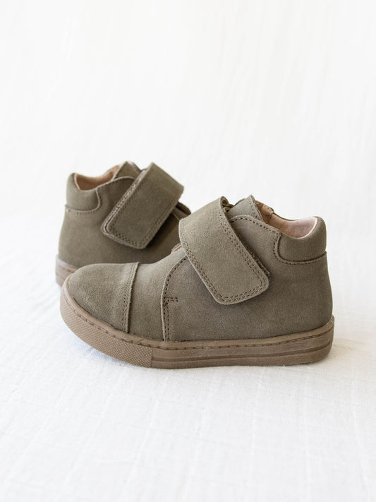 This Suede Mid Boot comes in a Sage color with a brown rubber sole and wide velcro strap across the top of the foot.