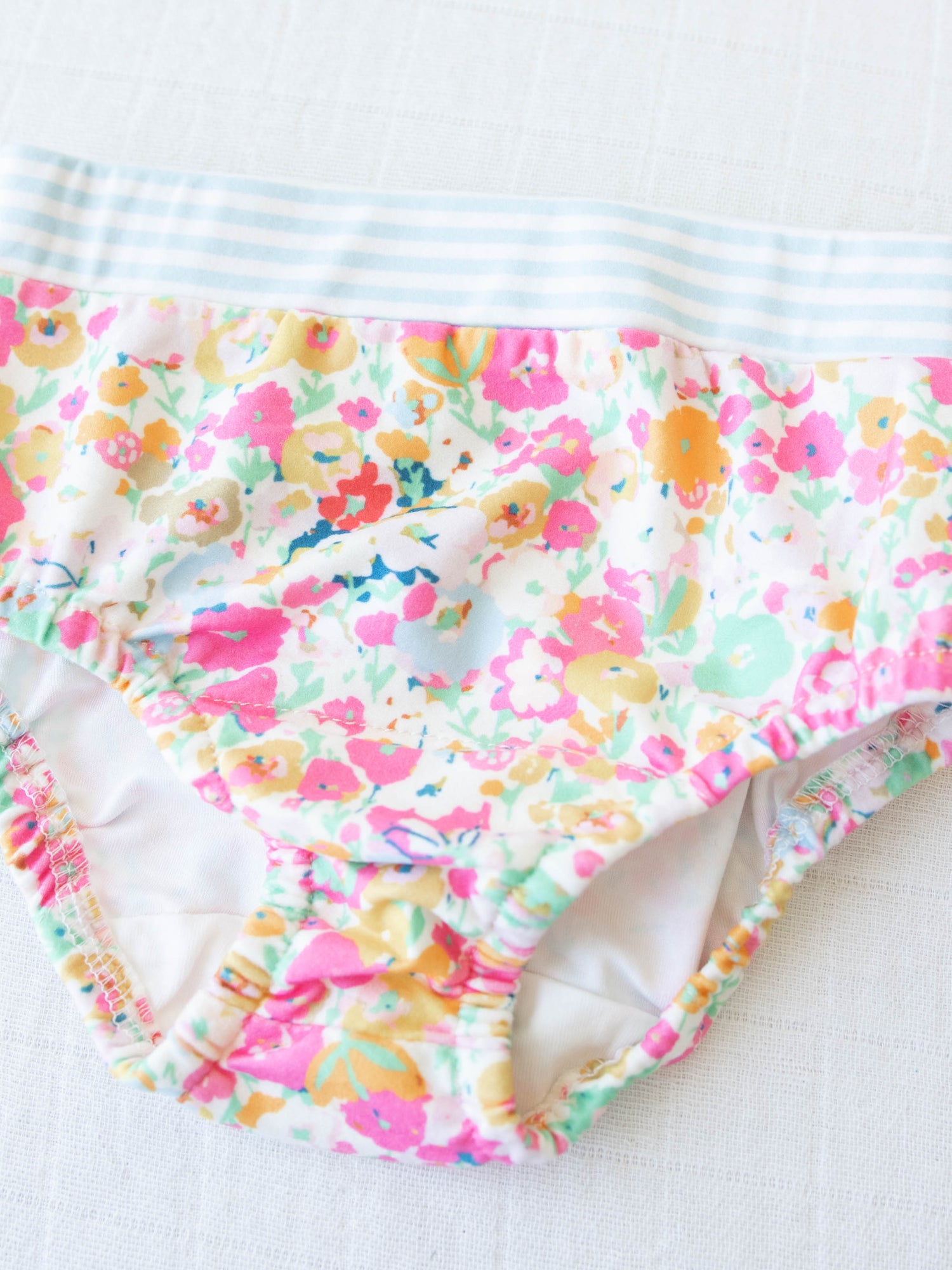 This pair in the set has a vibrant floral pattern mainly in pink, orange, and mint green.