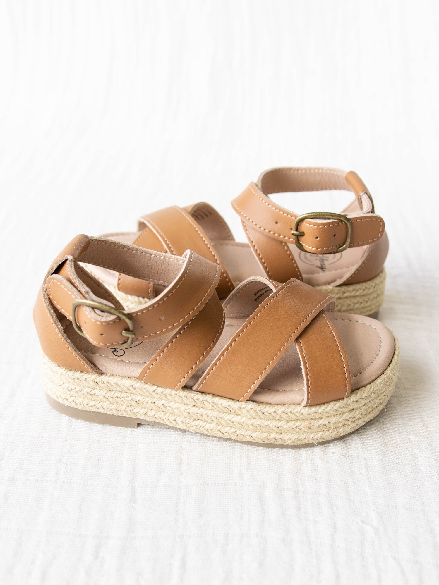 These brown leather Platform Sandals feature a closed back attached to an adjustable strap with metal buckle that wraps around the ankle. With a rubber sole and thick straps over the top of the foot, these sandals are prefect for a day on the go.