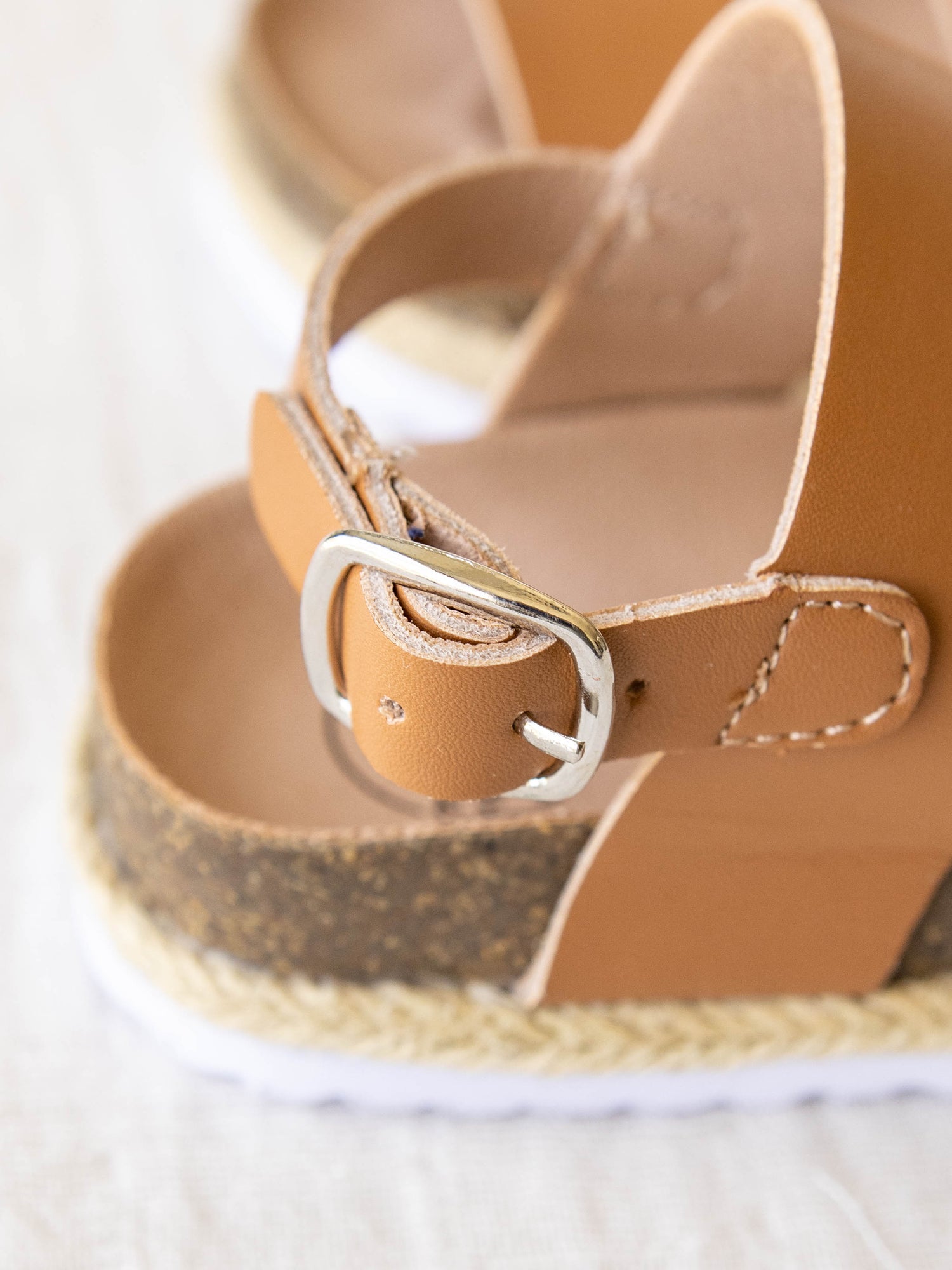 Closeup of the adjustable ankle strap and metal buckle.