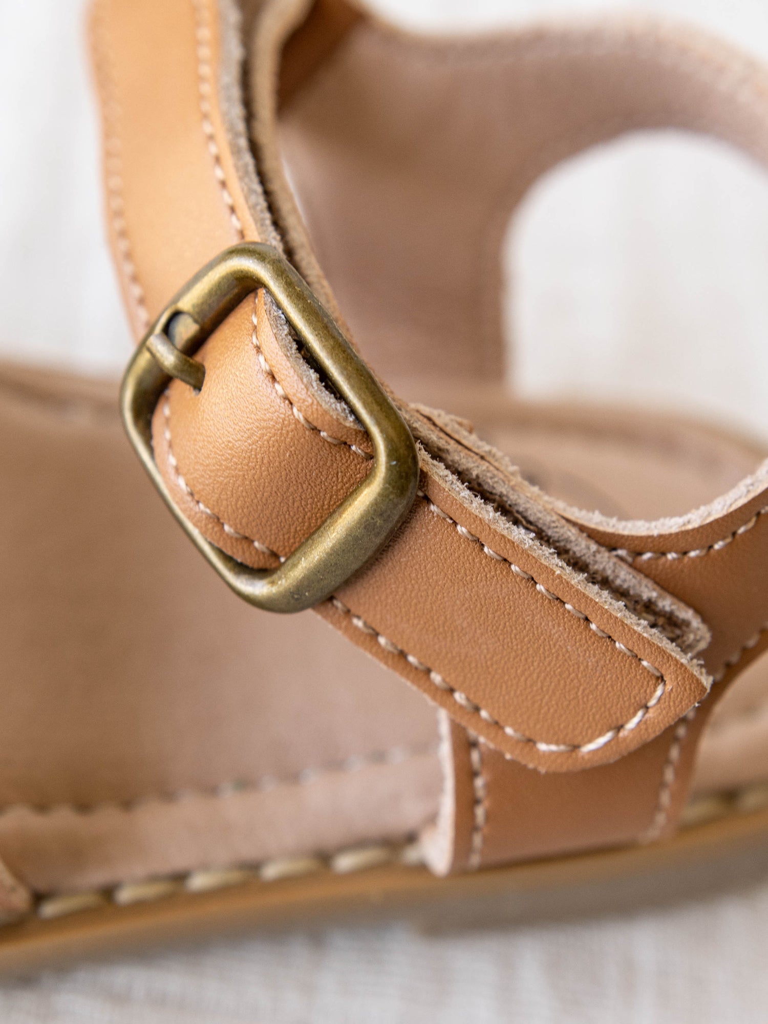 Closeup of the other buckle and the beautiful thread trim on these sandals.