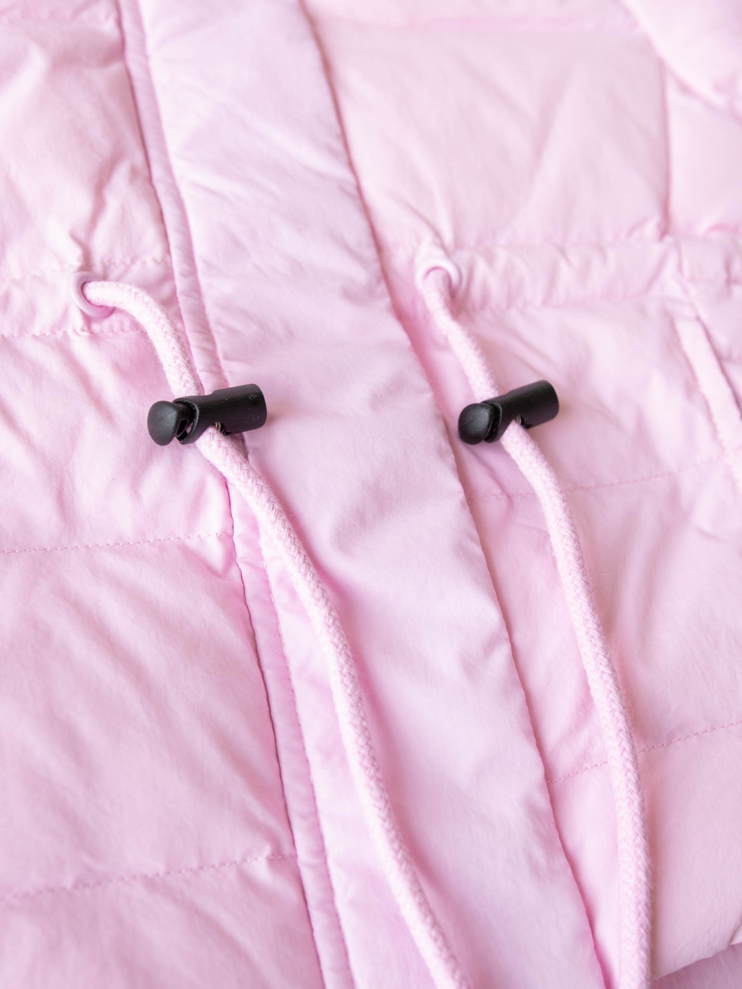 Keep her cozy and cute all season long in our Pink Puffer Jacket — the perfect blend of warmth and style! This soft, quilted jacket features a full zipper closure with a button placket, ensuring extra protection from chilly winds. Hidden front pockets keep little hands warm (or treasures tucked away), while the adjustable waist toggle allows for the perfect, comfortable fit. Designed in a beautiful blush pink hue, this girls’ puffer jacket pairs effortlessly with any winter outfit for a look that's fun!